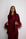 Woman wearing a burgundy outfit with feathered sleeves against a white background